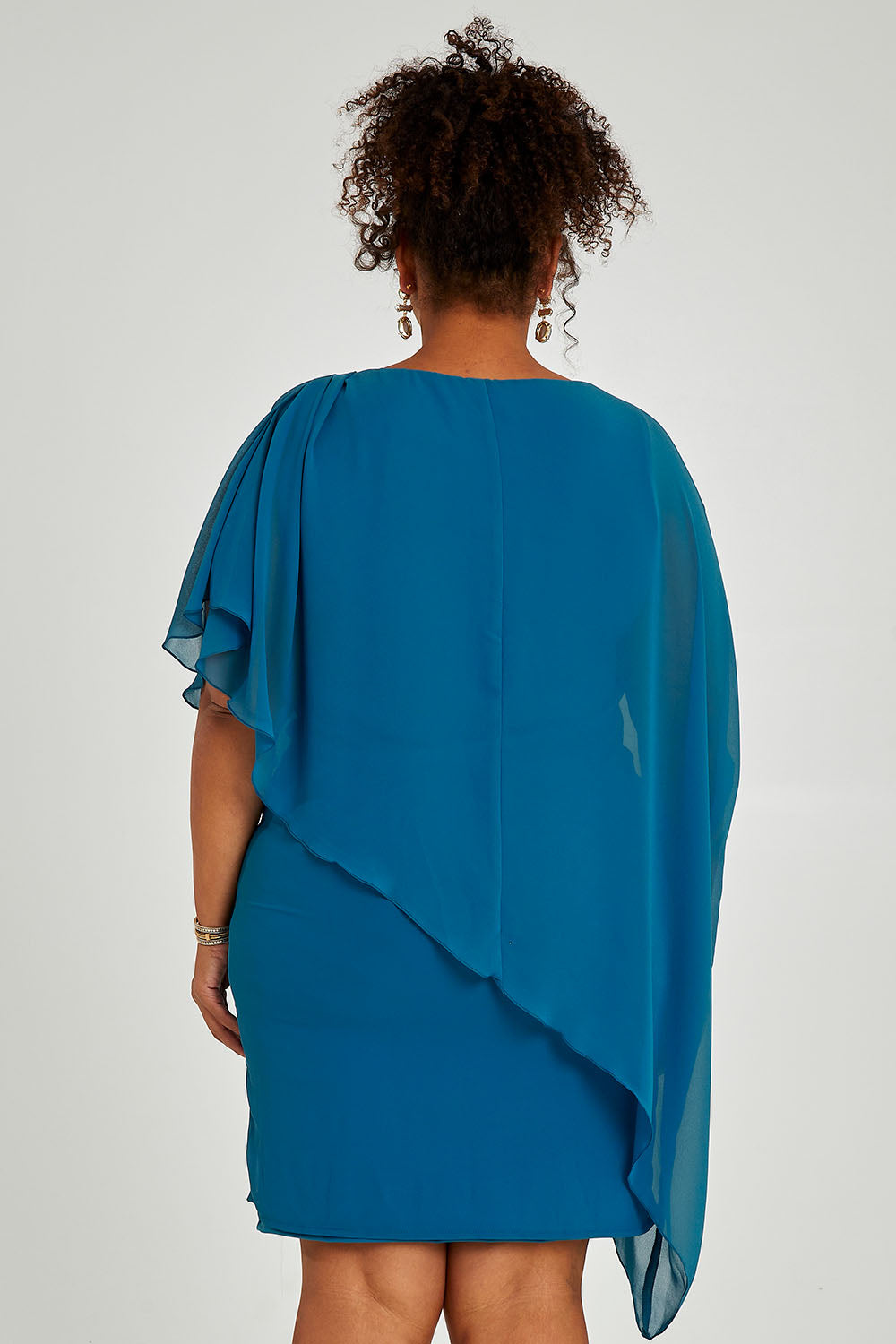 Model Alexis wearing size 16 of the Beatrice Dress in colour Teal (Blue), from the back