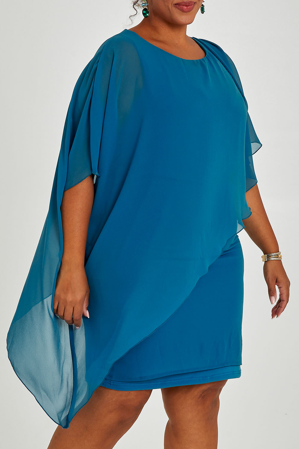 Model Alexis wearing size 16 of the Beatrice Dress in colour Teal (Blue), from the front, cropped image