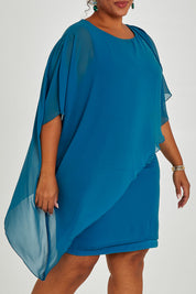 Model Alexis wearing size 16 of the Beatrice Dress in colour Teal (Blue), from the front, cropped image