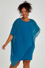 Model Alexis wearing size 16 of the Beatrice Dress in colour Teal (Blue), from the front, cropped image