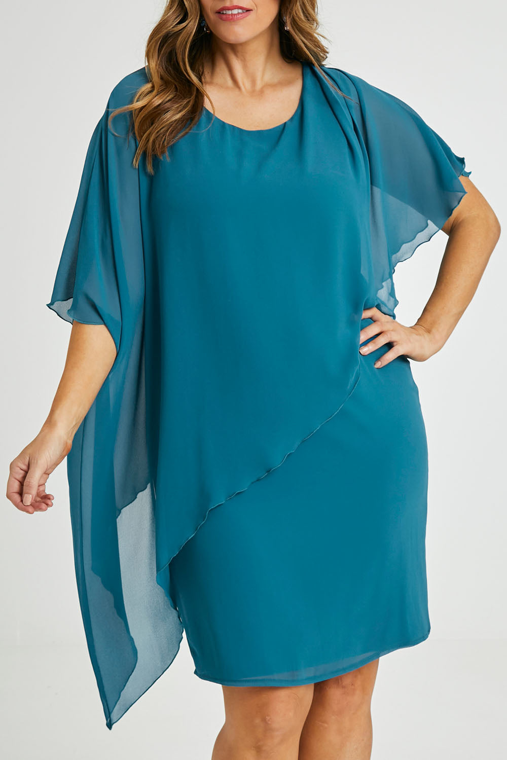 Model Laura wearing size 14 of the Beatrice Dress in colour Teal (Blue), from the front, cropped image
