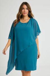 Model Laura wearing size 14 of the Beatrice Dress in colour Teal (Blue), from the front, cropped image