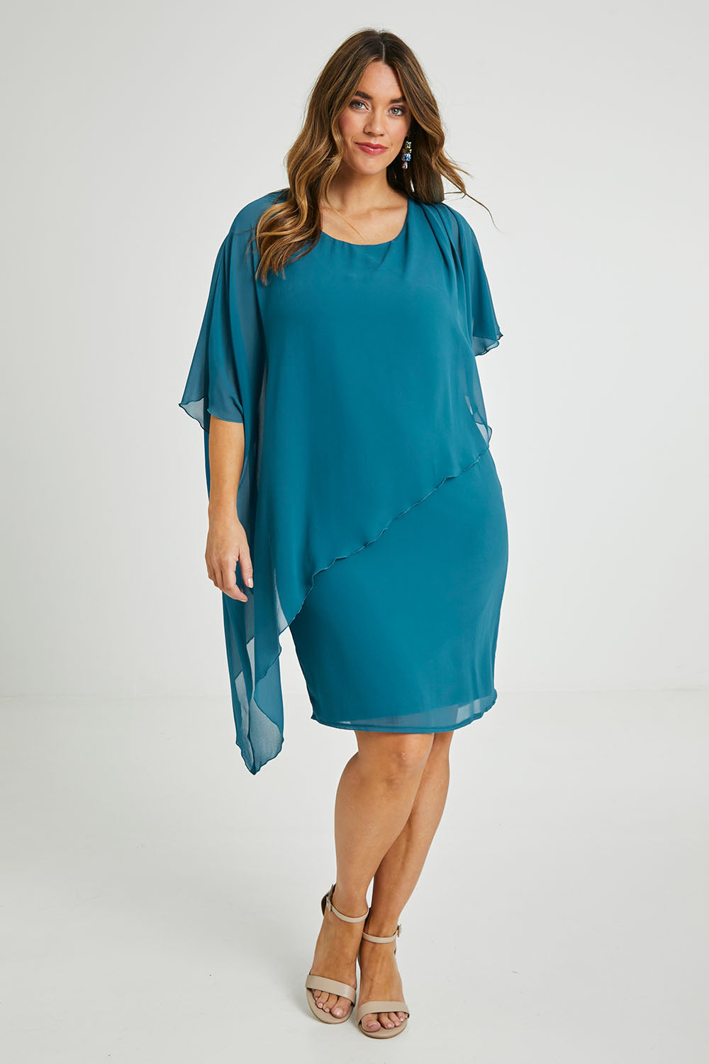 Model Laura wearing size 14 of the Beatrice Dress in colour Teal (Blue), from the front, showing the whole outfit