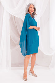 Model Luisa wearing size 10 of the Beatrice Dress in colour Teal (Blue), from the front, showing the whole outfit