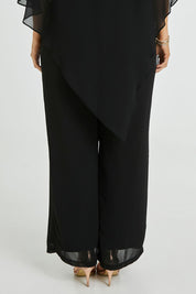 Model Laura wearing size 12 of the Marie Pants in colour Black (Black), from the back
