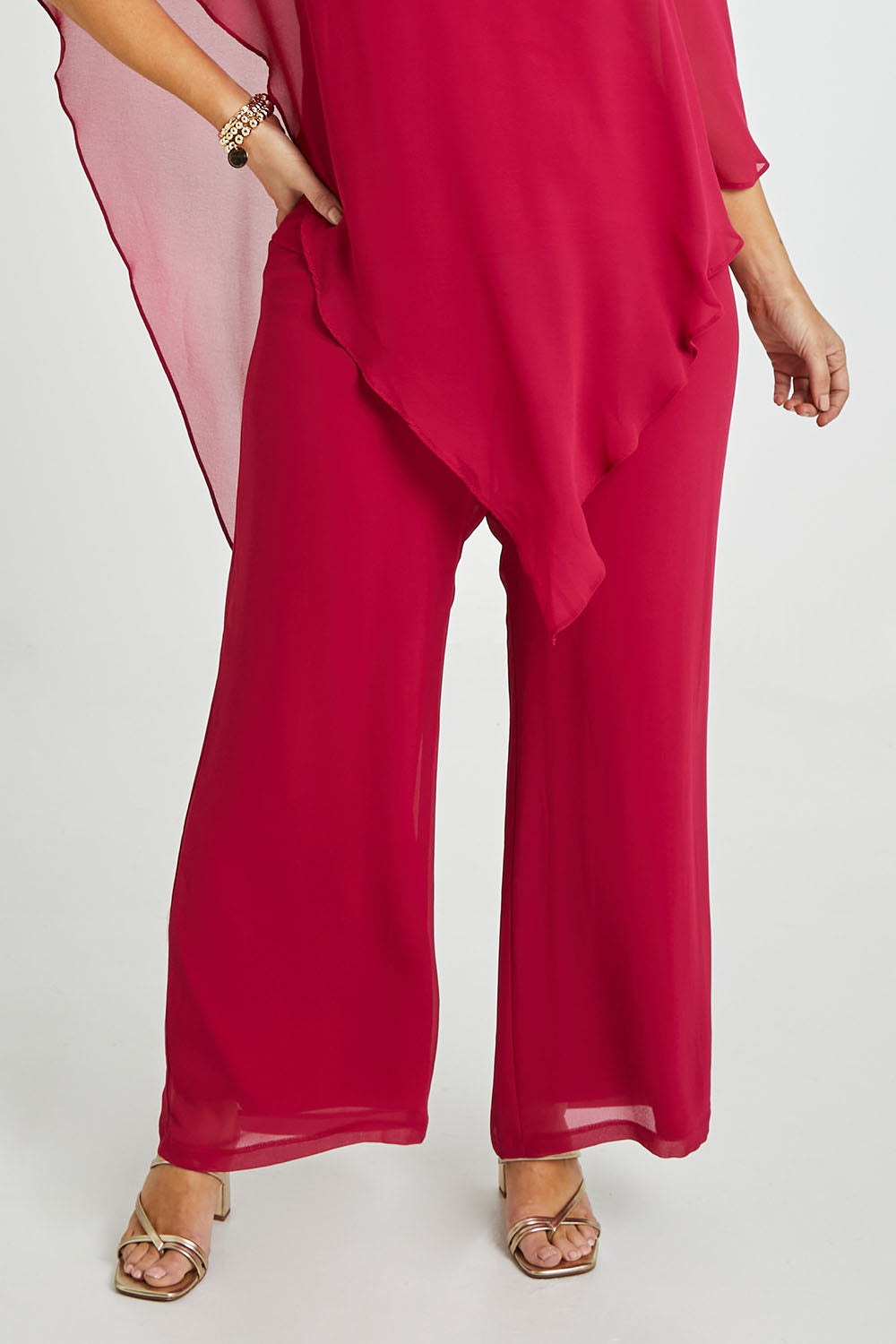 Model Laura wearing size 14 of the Marie Pants in colour Granita (Pink), from the front, cropped image