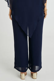Model Laura wearing size 14 of the Marie Pants in colour Navy (Blue), from the back