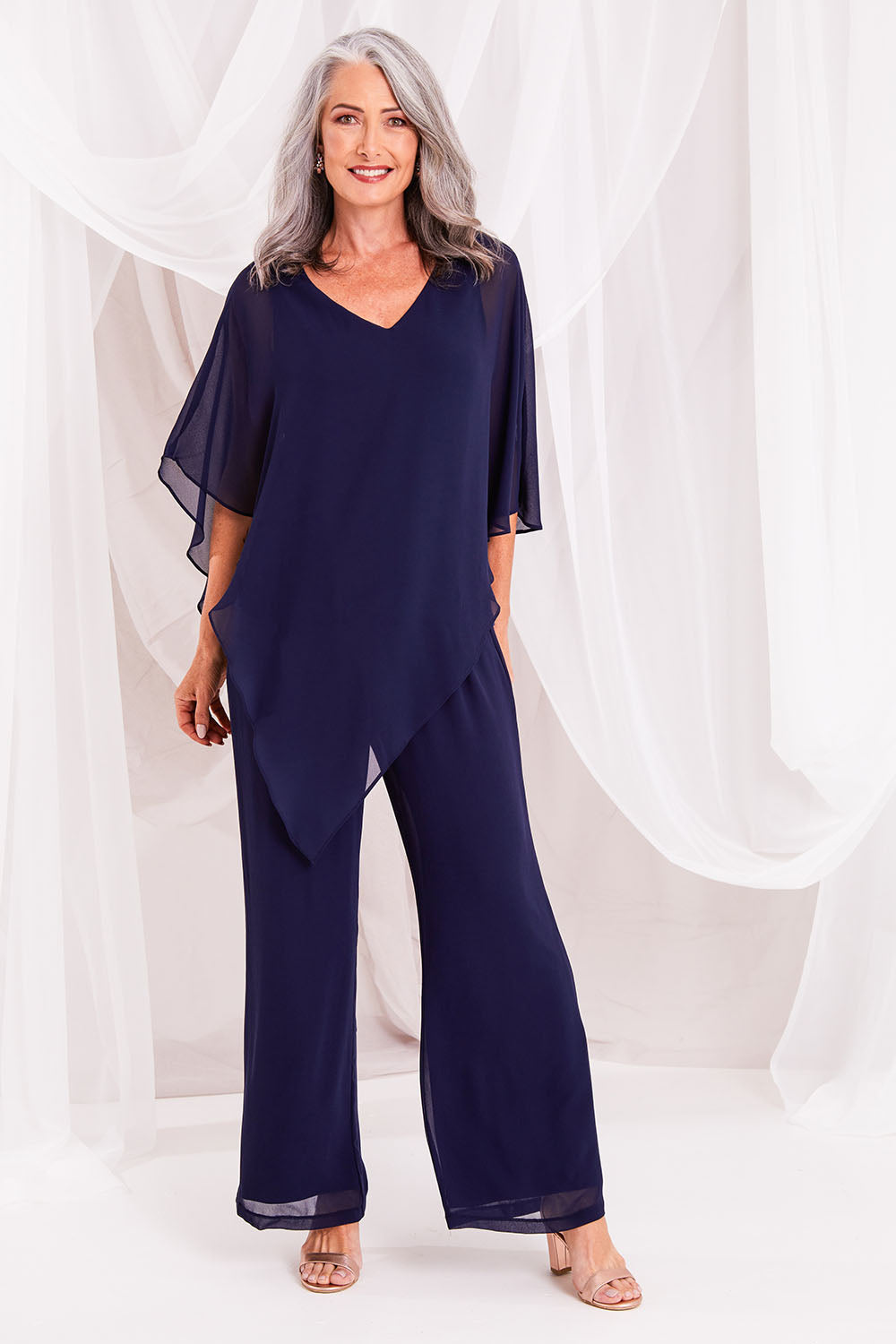 Model Luisa wearing size 10 of the Marie Pants in colour Navy (Blue), from the front, showing the whole outfit