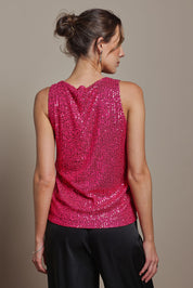 Model Madeline wearing size 10 of the Reece Top in colour Cerise (Metallics), from the back