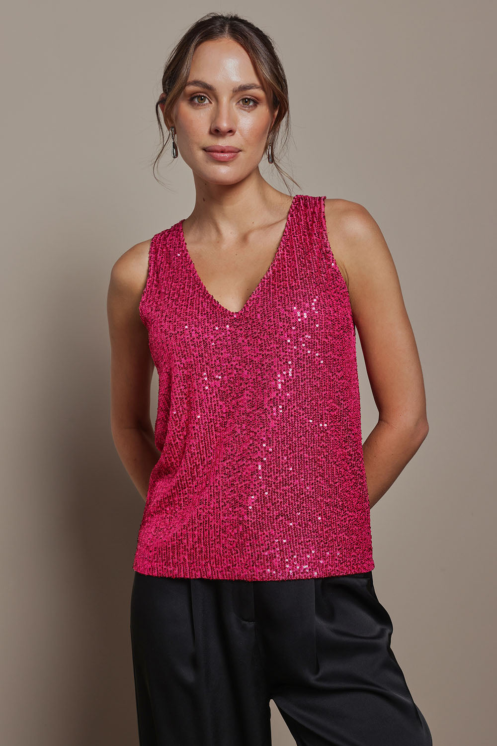 Model Madeline wearing size 10 of the Reece Top in colour Cerise (Metallics), from the front, cropped image