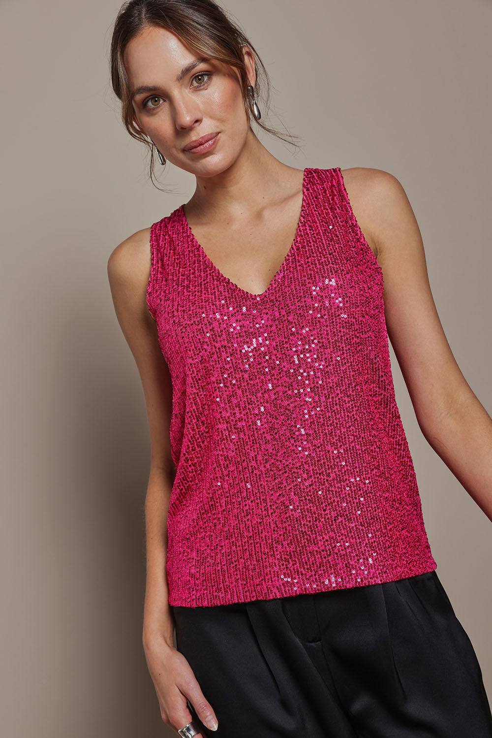 Model Madeline wearing size 10 of the Reece Top in colour Cerise (Metallics), from the front, cropped image