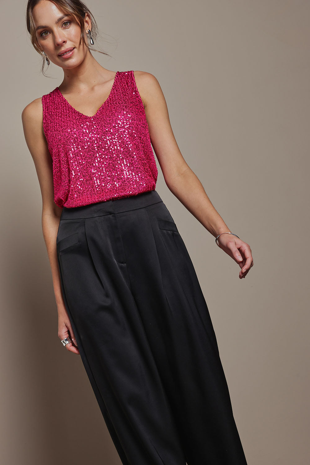 Model Madeline wearing size 10 of the Reece Top in colour Cerise (Metallics), from the front, showing the whole outfit