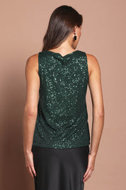 Model Madeline wearing size 10 of the Reece Top in colour Forest (Metallics), from the back