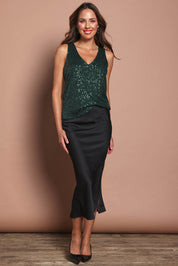 Model Madeline wearing size 10 of the Reece Top in colour Forest (Metallics), from the front, showing the whole outfit