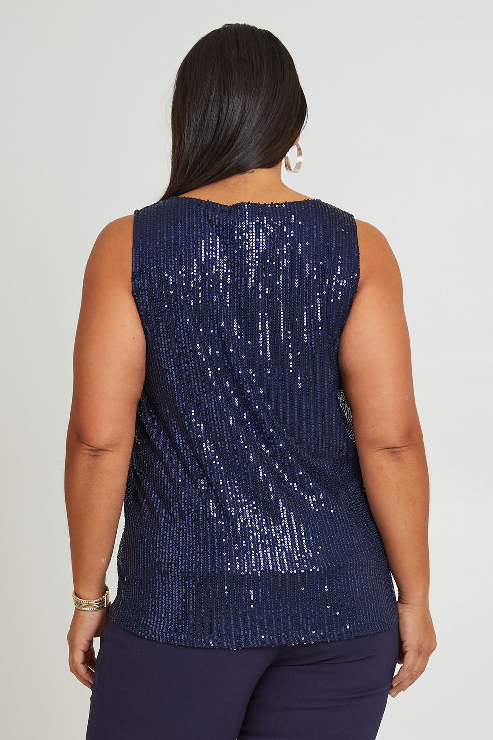 Model Ashleigh wearing size 16 of the Reece Top in colour Navy (Blue), from the back