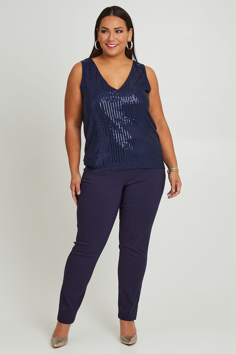 Model Ashleigh wearing size 16 of the Reece Top in colour Navy (Blue), from the front, showing the whole outfit