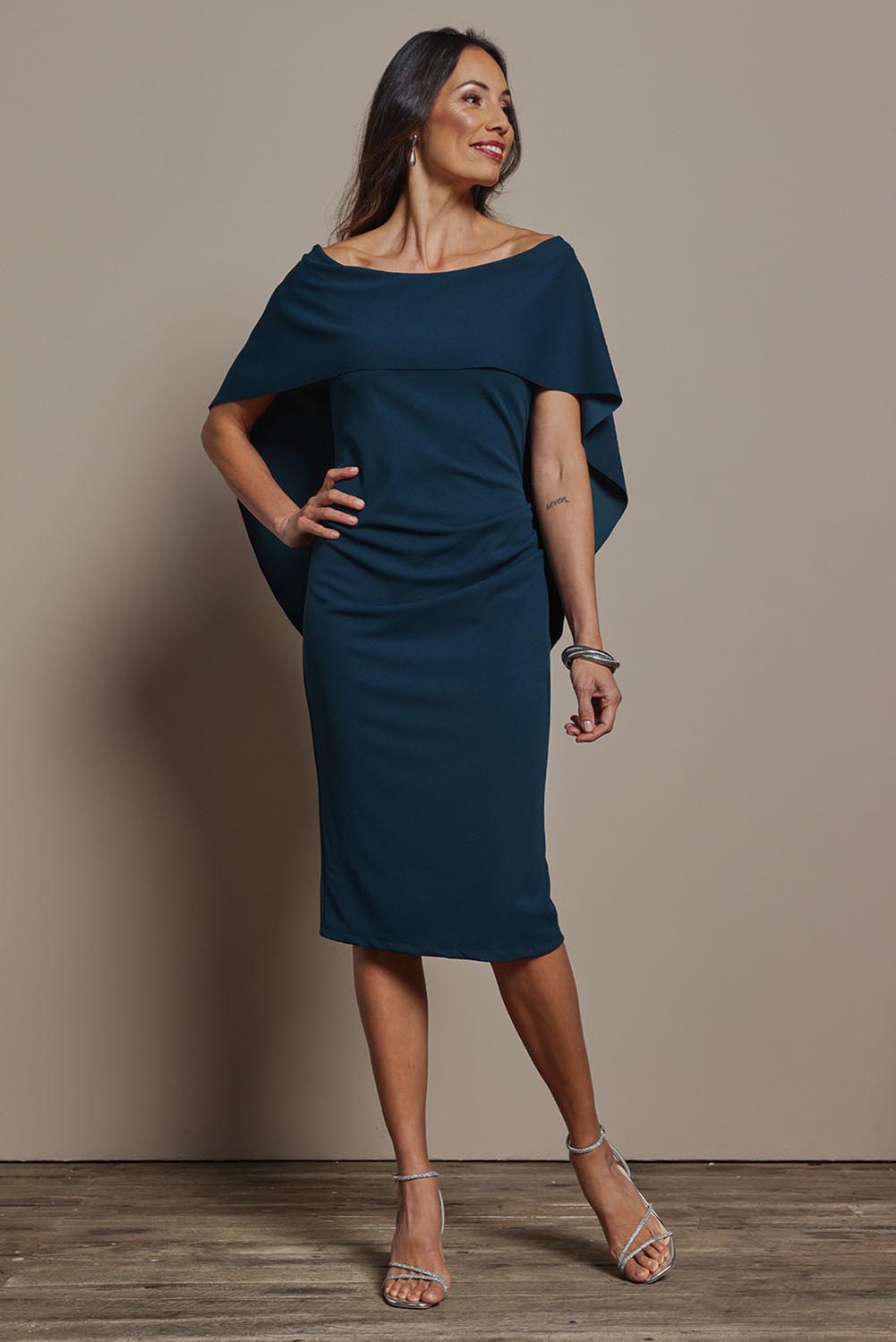 Model Amanda wearing size 10 of the Cora Dress in colour Darkteal (Green), from the front, showing the whole outfit
