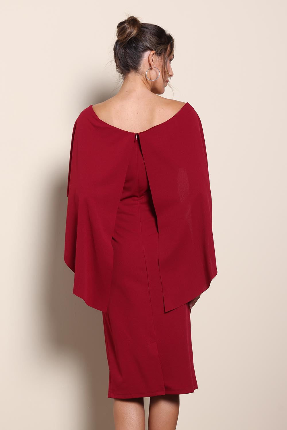 Model Maddiec wearing size 10 of the Cora Dress – Garnet in colour Garnet, from the back