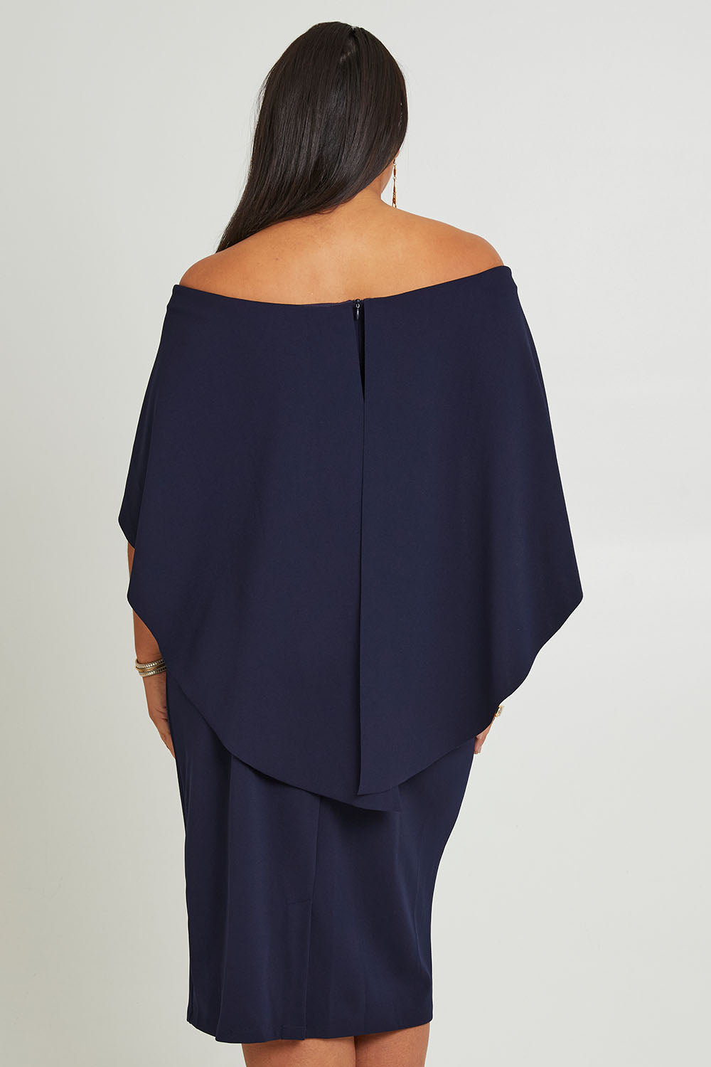 Model Ashleigh wearing size 16 of the Cora Dress in colour Navy (Blue), from the back