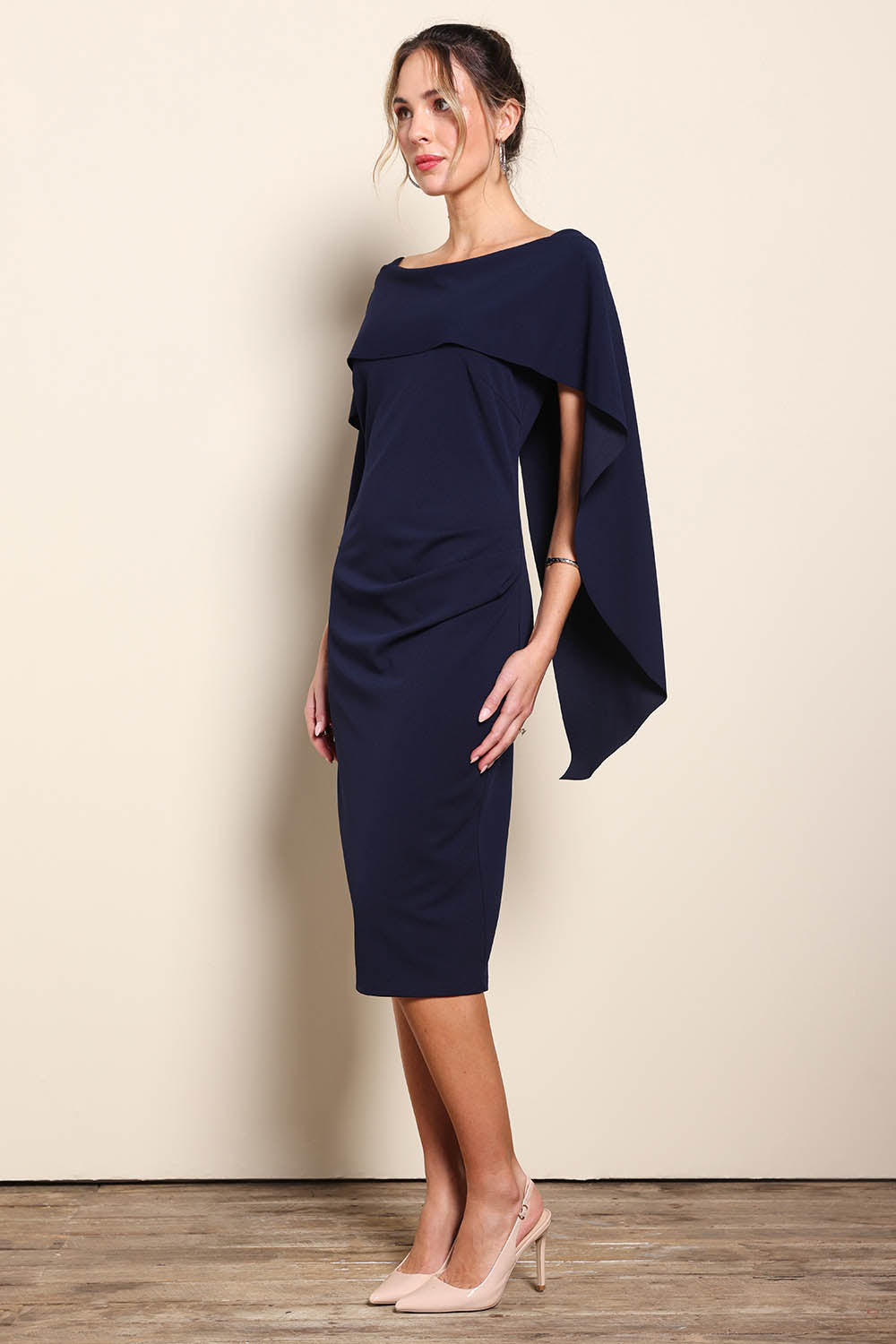 Model Maddiec wearing size 10 of the Cora Dress - Navy in colour Navy, from the front
