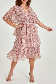 Model Maddy wearing size 16 of the Sadie Dress in colour Blushfleur (Pink), from the front, cropped image