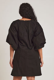 Model Terri-Leigh wearing size 14 of the Belinda Dress in colour Black (Black), from the back
