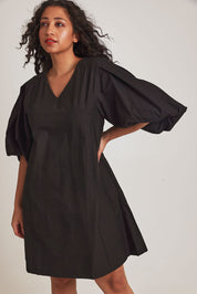 Model Terri-Leigh wearing size 14 of the Belinda Dress in colour Black (Black), from the front, cropped image
