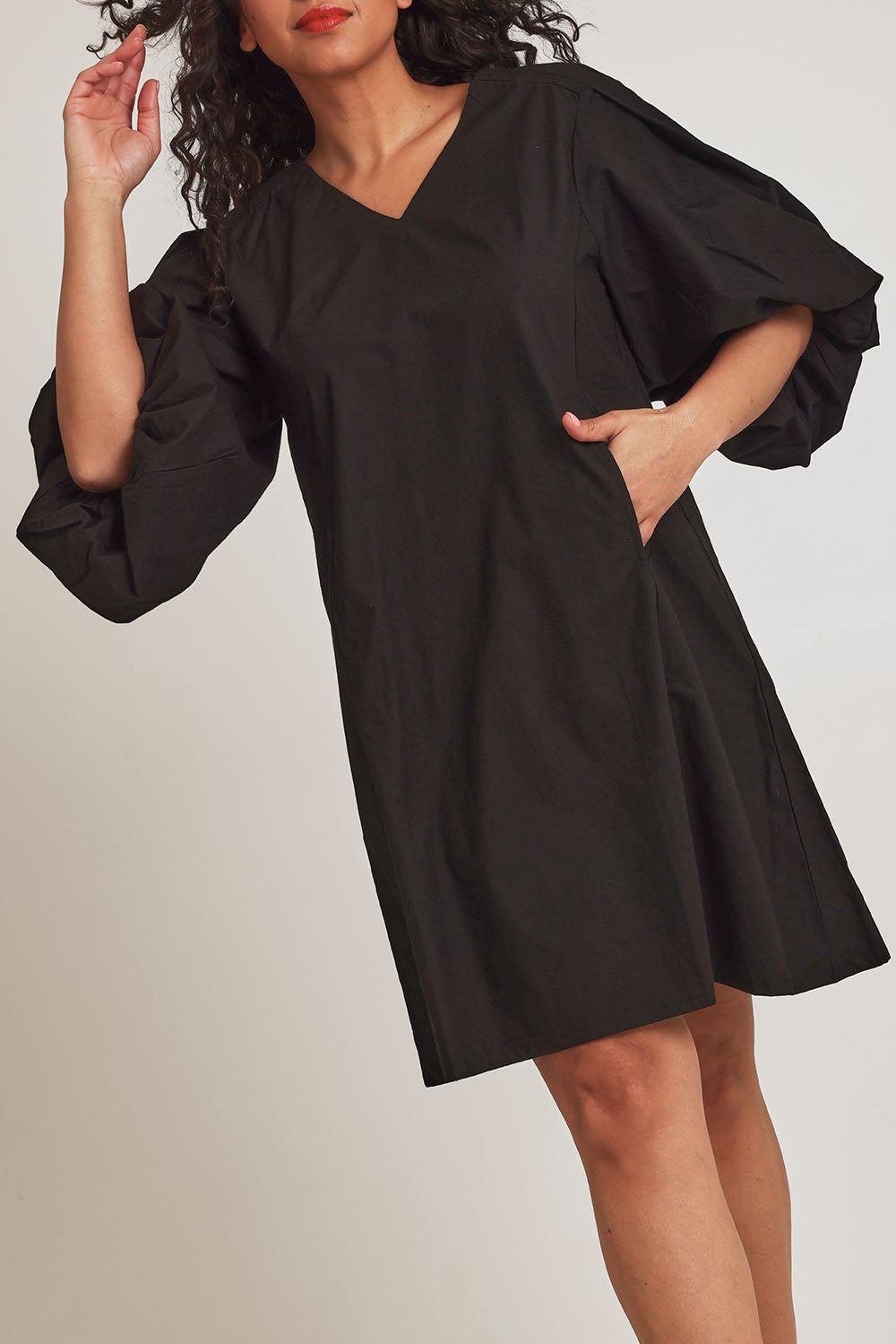 Model Terri-Leigh wearing size 14 of the Belinda Dress in colour Black (Black), from the front, cropped image
