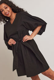 Model Terri-Leigh wearing size 14 of the Belinda Dress in colour Black (Black), from the front, cropped image