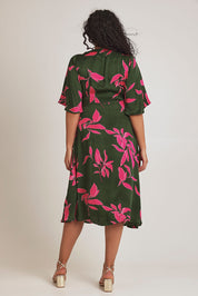 Model Terri-Leigh wearing size 14 of the Ailin Wrap Dress in colour Vividflora (Green), from the back