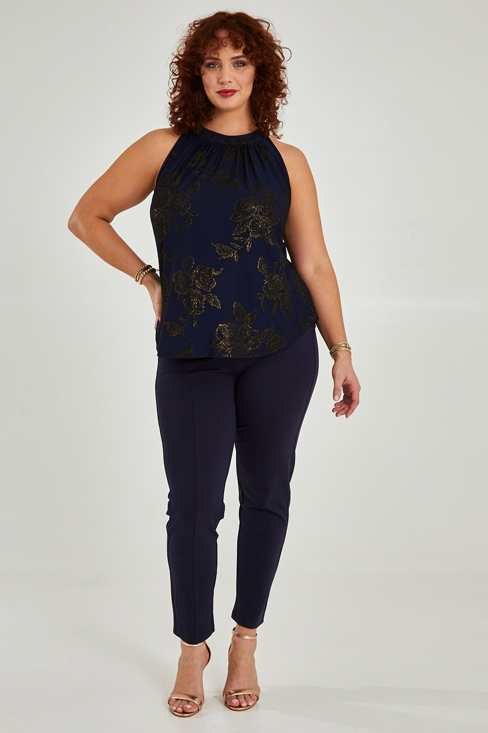 Model Maddy wearing size 16 of the Cara Top in colour Navygold (Blue), from the front, showing the whole outfit