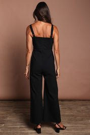 Model Amanda wearing size 10 of the Veronica Jumpsuit in colour Black (Black), from the back