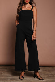 Model Amanda wearing size 10 of the Veronica Jumpsuit in colour Black (Black), from the front, cropped image