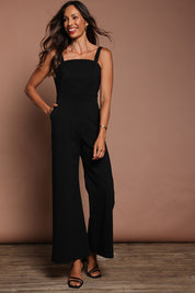 Model Amanda wearing size 10 of the Veronica Jumpsuit in colour Black (Black), from the front, showing the whole outfit