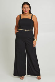 Model Ashleigh wearing size 16 of the Veronica Jumpsuit in colour Black (Black), from the front, showing the whole outfit