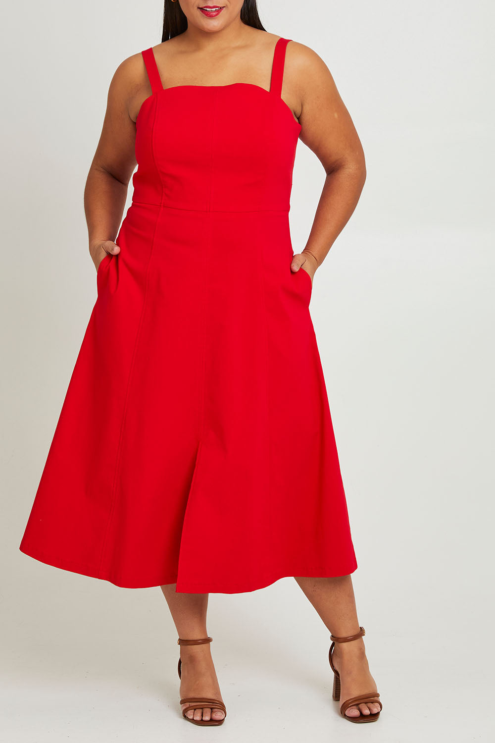 Model Ashleigh wearing size 16 of the Carmen Dress in colour Flame (Red), from the front, cropped image