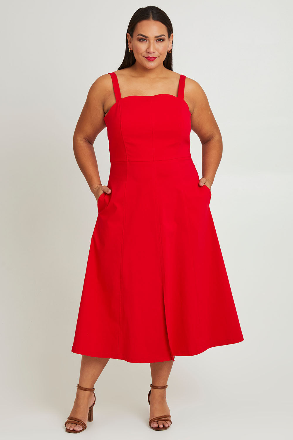 Model Ashleigh wearing size 16 of the Carmen Dress in colour Flame (Red), from the front, showing the whole outfit