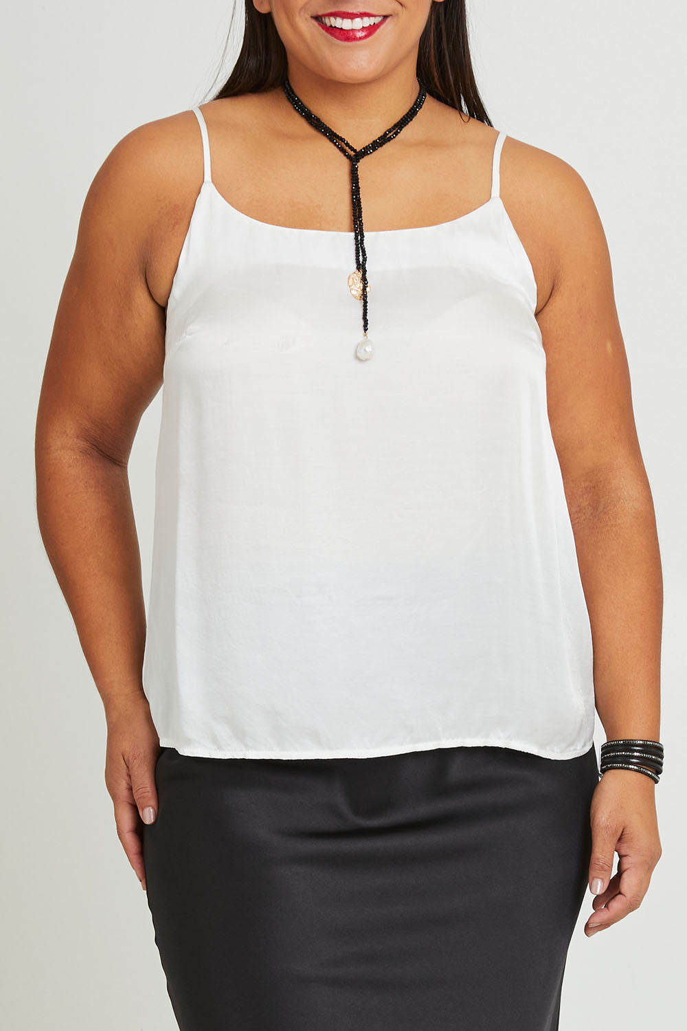 Model Ashleigh wearing size 16 of the Clarice Camisole in colour Snow (White), from the front, cropped image