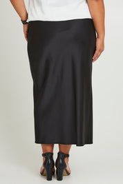 Model Ashleigh wearing size 16 of the Sienna Skirt in colour Black (Black), from the back