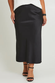 Model Ashleigh wearing size 16 of the Sienna Skirt in colour Black (Black), from the front, cropped image
