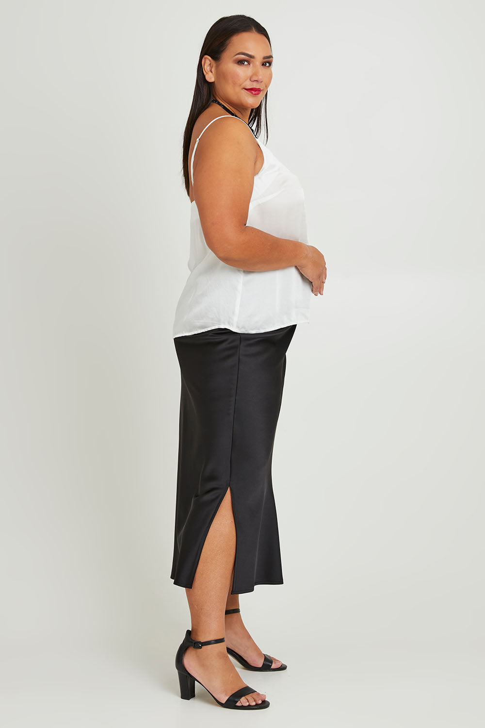 Model Ashleigh wearing size 16 of the Sienna Skirt in colour Black (Black), from the front, showing the whole outfit