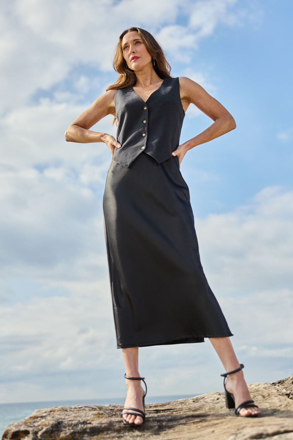 Model Clementine wearing size 10 of the Sienna Skirt in colour Black (Black), from the front, showing the whole outfit
