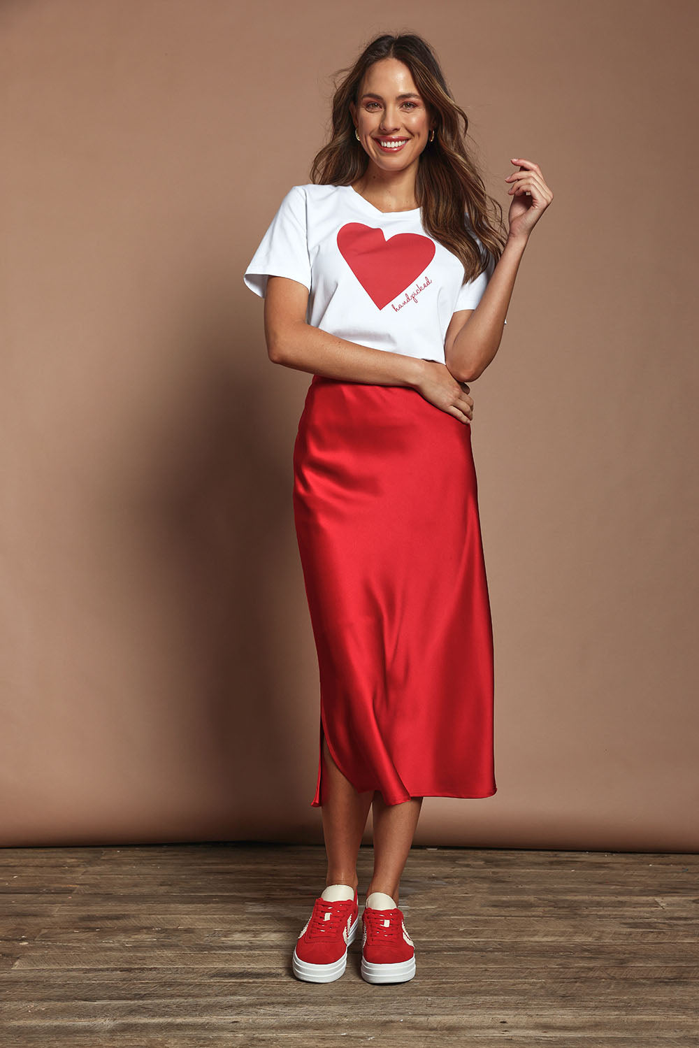 Model Amanda wearing size 10 of the Loulou Satin Skirt in colour Red (Red), from the front, showing the whole outfit