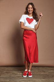 Model Amanda wearing size 10 of the Loulou Satin Skirt in colour Red (Red), from the front, showing the whole outfit