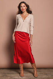 Model Madeline wearing size 10 of the Loulou Satin Skirt in colour Red (Red), from the front, showing the whole outfit