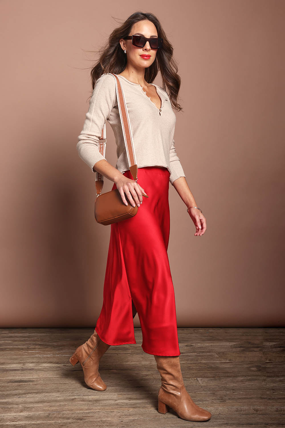 Model Madeline wearing size 10 of the Loulou Satin Skirt in colour Red (Red), from the front, showing the whole outfit