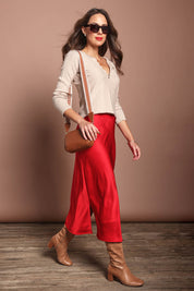 Model Madeline wearing size 10 of the Loulou Satin Skirt in colour Red (Red), from the front, showing the whole outfit