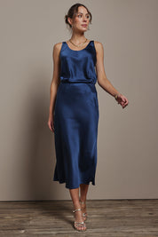 Model Madeline wearing size 10 of the Loulou Satin Skirt in colour Steelblue (Blue), from the front, showing the whole outfit