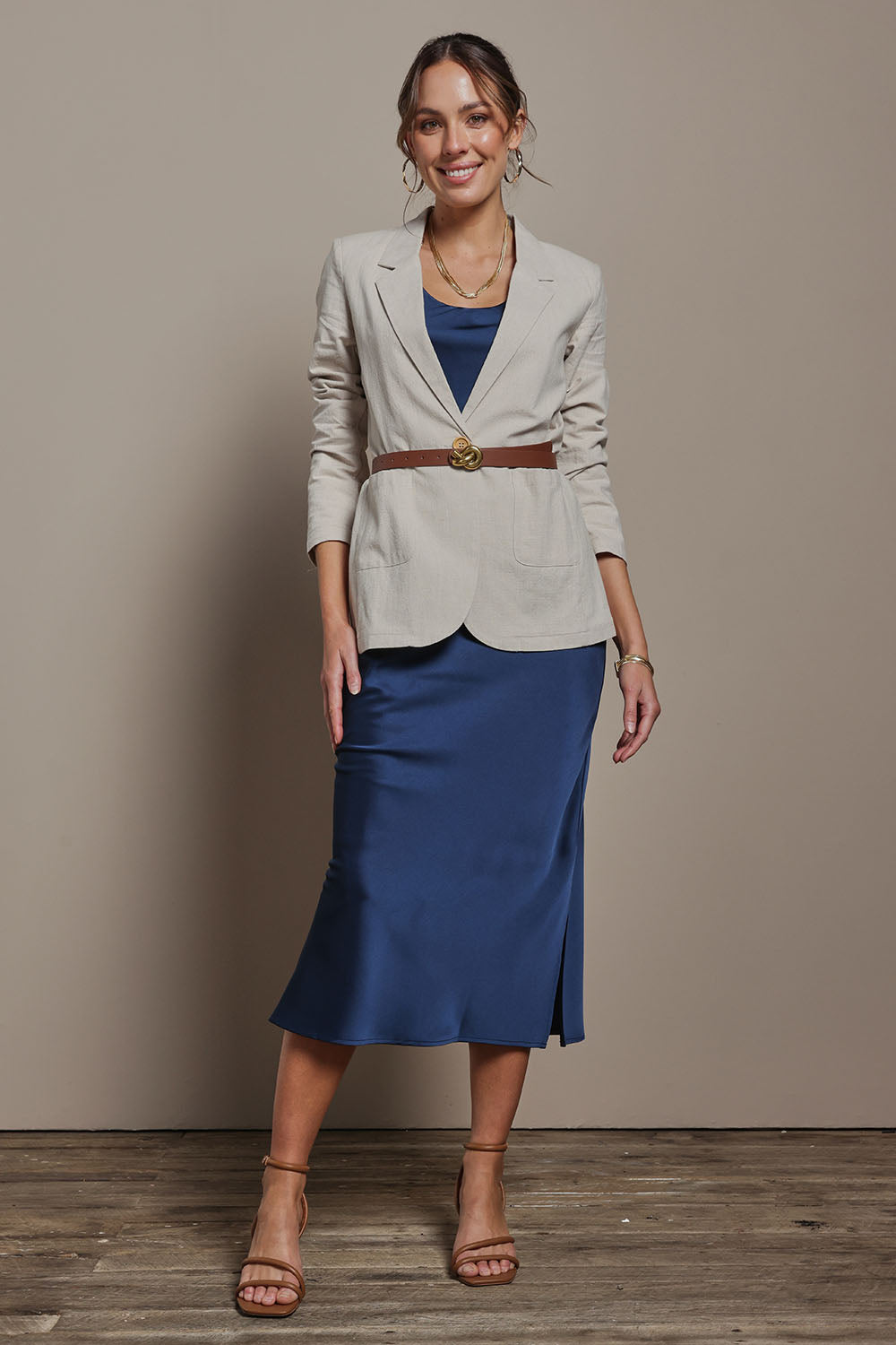 Model Madeline wearing size 10 of the Loulou Satin Skirt in colour Steelblue (Blue), from the front, showing the whole outfit