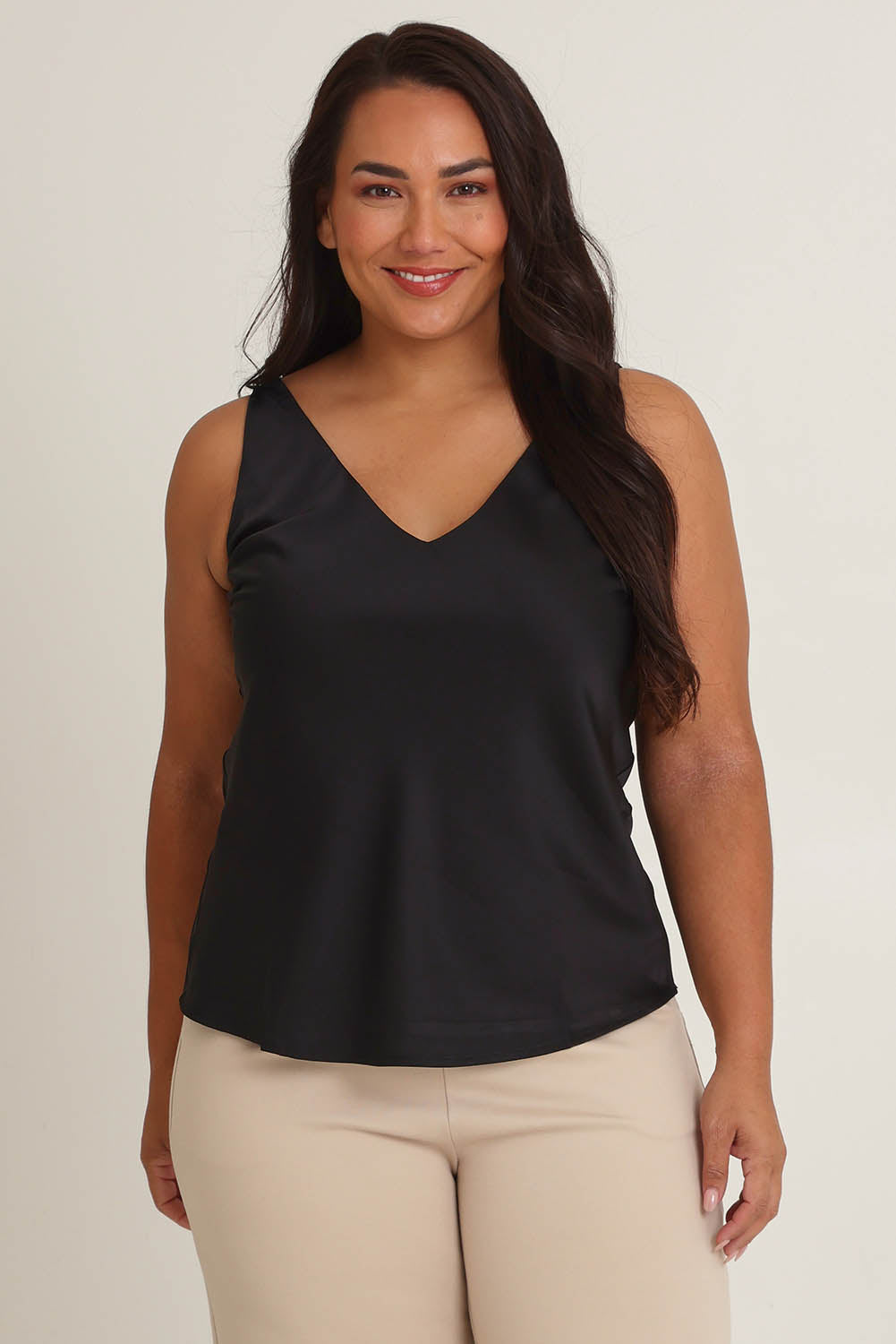 Model Ashleigh wearing size 16 of the Loulou Satin Camisole in colour Black (Black), from the front, cropped image